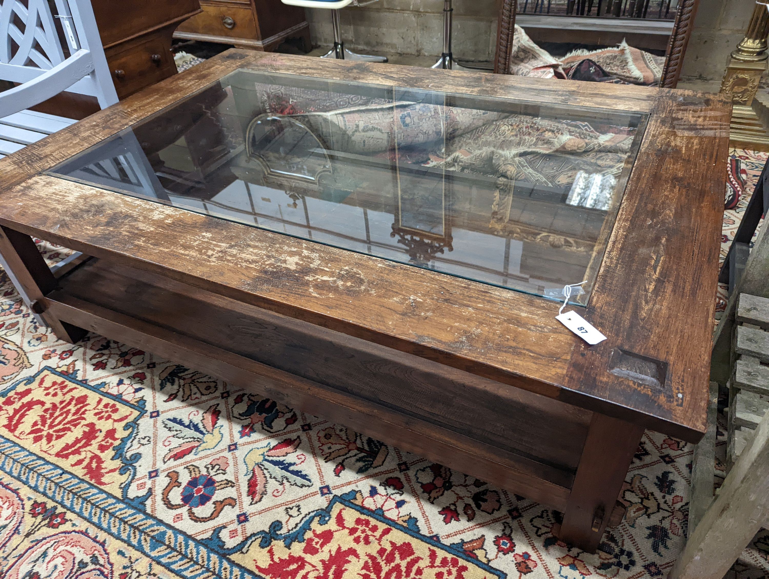 A large rectangular glass top hardwood two tier coffee table, length 160cm, width 110cm, height 49cm
